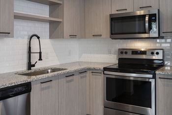 black appliances in kitchen with cabinets at Azola West Palm Beach, Florida, 33411